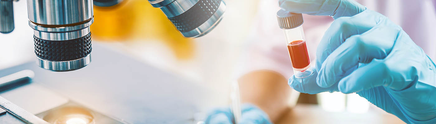 A researcher analysing a blood sample.
